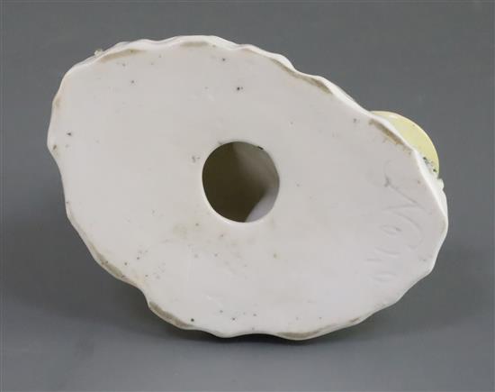 A Rockingham porcelain group of a kneeling girl playing with a kitten, c.1830, h. 10.5cm, small losses